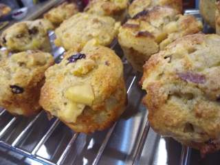 Spiced Pear and Cranberry Muffins Muffins with bits of cranberry and pear visible