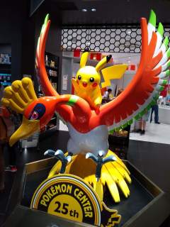 Pikachu riding Ho-oh - a 25th Anniversary statue A large statue of Pikachu riding Ho-oh, with a sign below them saying in English, 'POKEMON CENTER 25th'