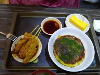 Okonomiyaki, yakitori, and tamagoyaki Okonomiyaki (a cabbage pancake), yakitori (chicken on a stick), and tamagoyaki (egg omelet)